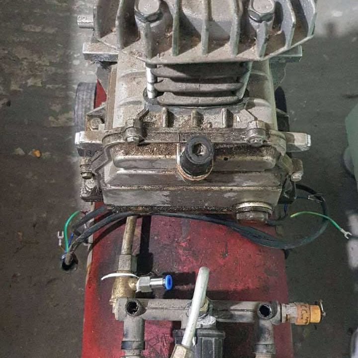 reparatii scule Un motor industrial expus pe un banc de lucru, cu diverse componente mecanice.